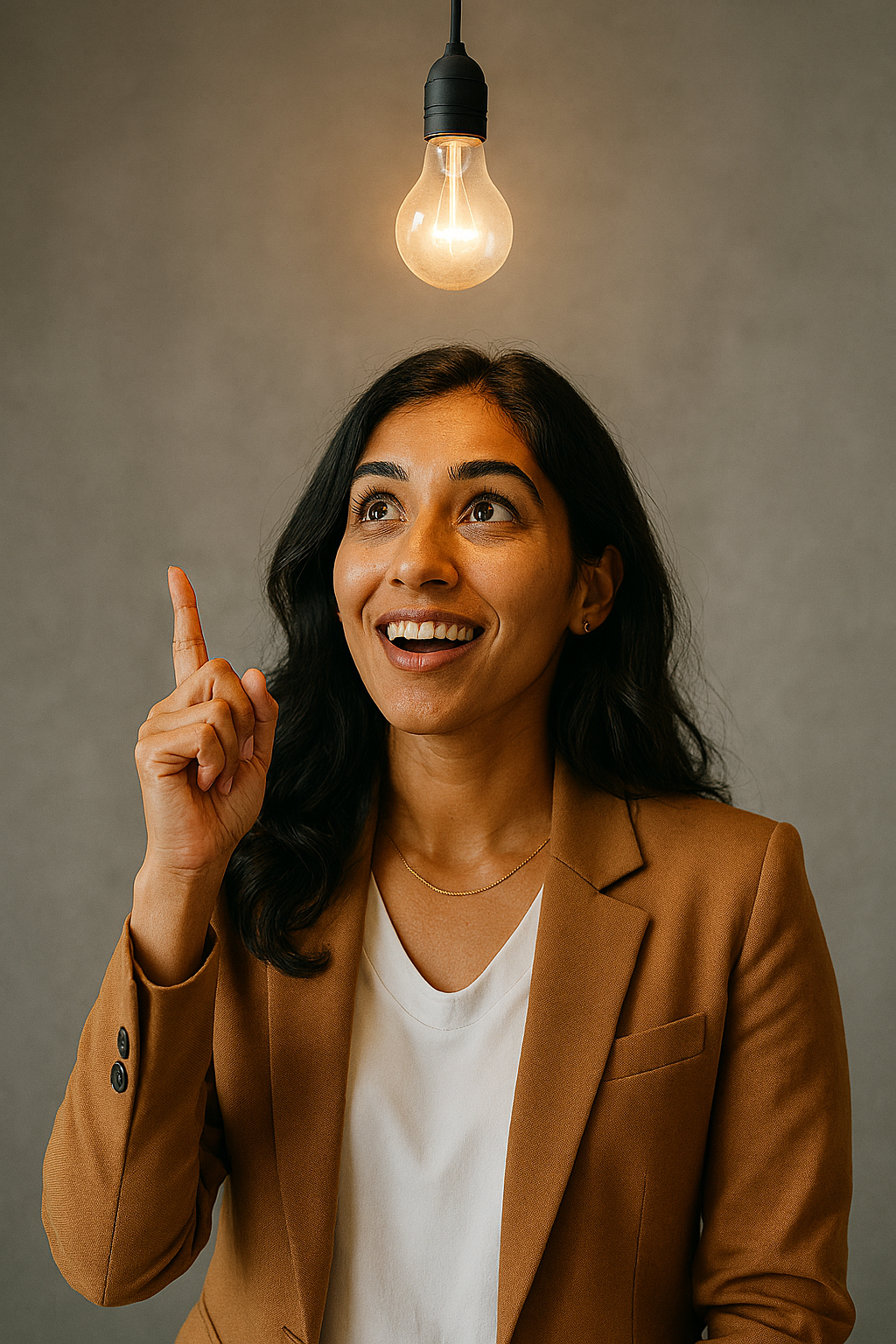 A professional woman having a creative idea moment under a glowing lightbulb, representing innovative thinking and entrepreneurial mindset taught at AIHM.